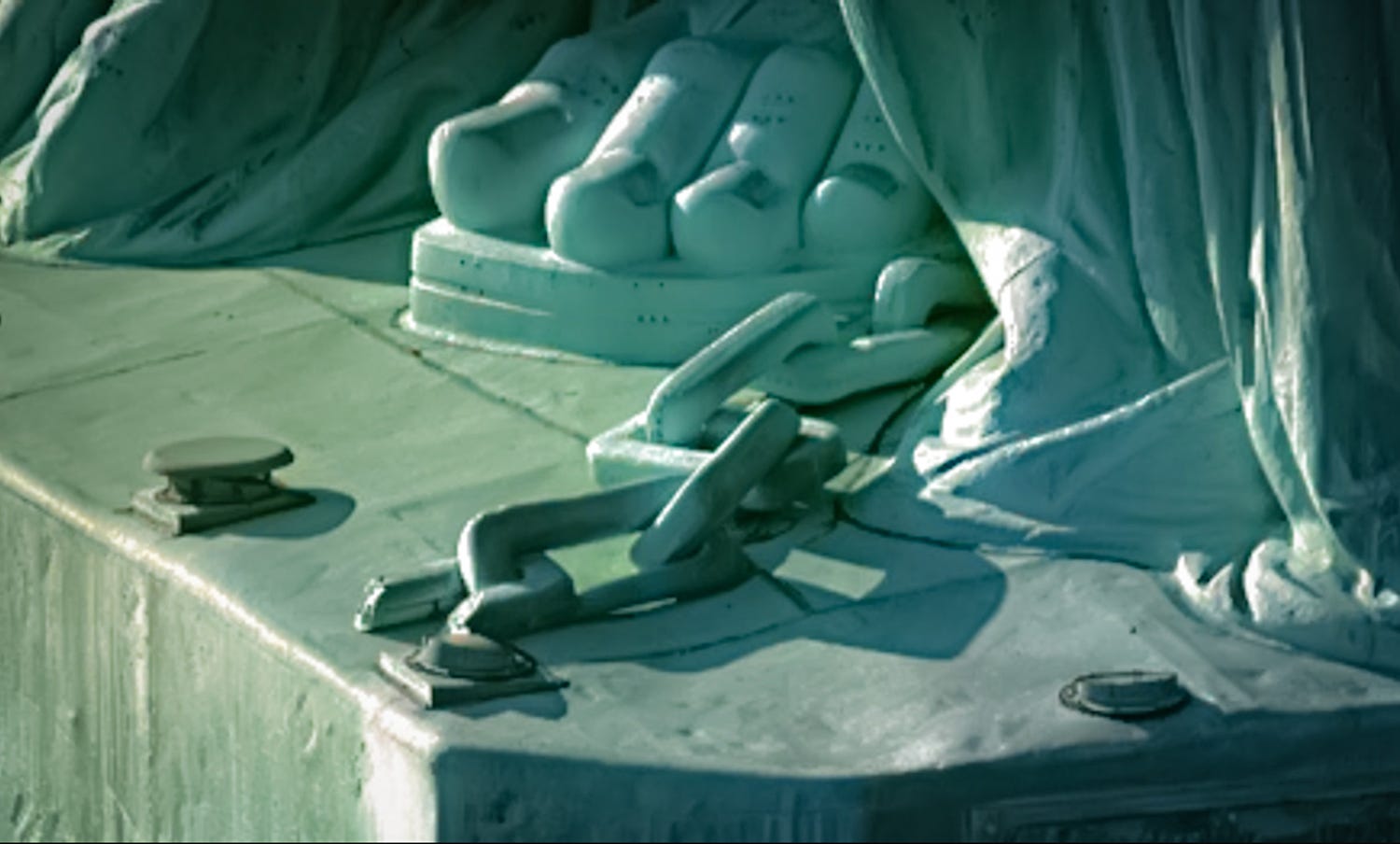 The broken chains at the feet of the Statue of Liberty — Satan's chains from Revelation 20